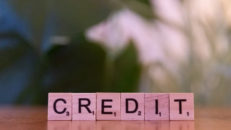 Person reviewing a credit report on a laptop to find ways to improve your credit score