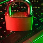 Person using a laptop and phone to protect your online accounts with a passkey and multi-factor login