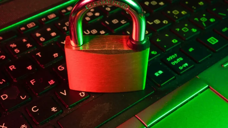 Person using a laptop and phone to protect your online accounts with a passkey and multi-factor login
