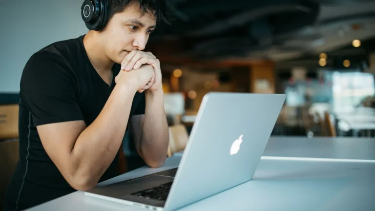 Student at a home desk with a laptop and notebook applying online learning tips during a virtual class