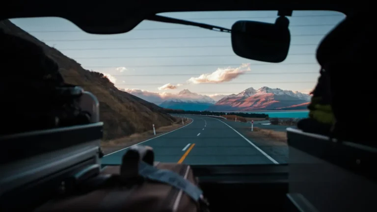 Car driving along a scenic open highway, showing the payoff of careful road trip planning